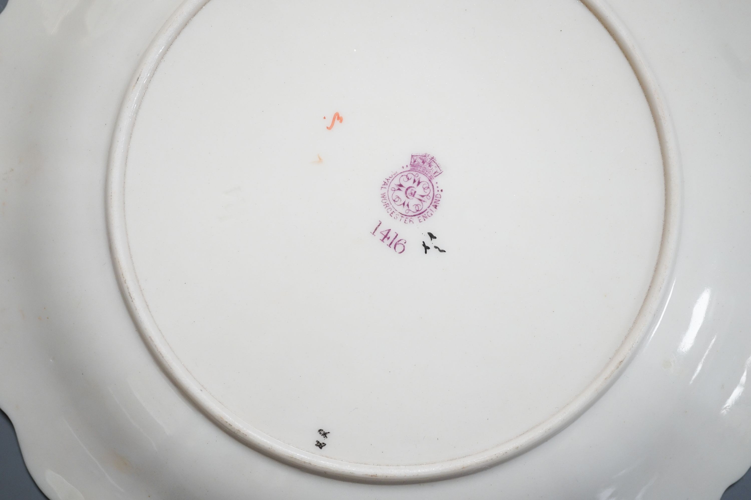 A Royal Worcester fine moulded plate painted and gilded with Strawberries by William Hale, signed WH verso, date mark 1890 and a pair of ivory moulded plates painted and gilded with tree branches, largest diameter 23cm